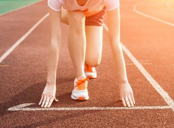 Athletic woman running on track