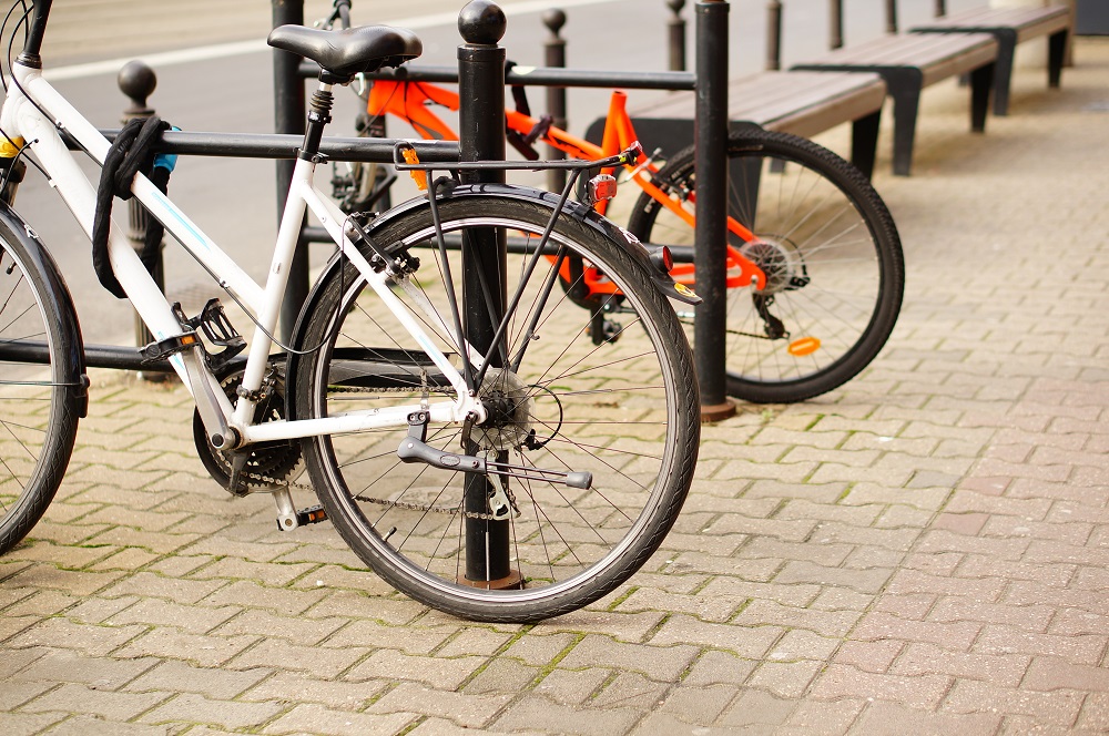 Low angle closeup shot of two bicycles parked on the sidewalk