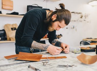 Working process of the leather bag in the leather workshop. Man