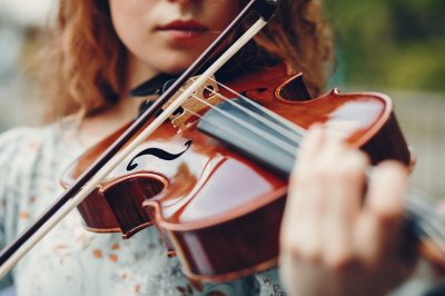 Beautiful girl in a summer park with a violin Beautiful girl in a summer park with a violin