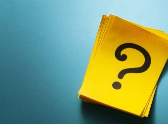 Stack of colorful yellow cards with question mark