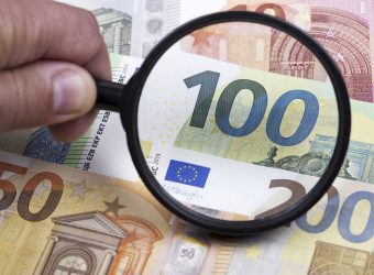 European money in a magnifying glass a business background