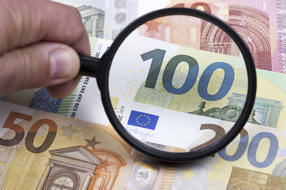 European money in a magnifying glass a business background