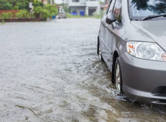 Car parking on the street of village while raining