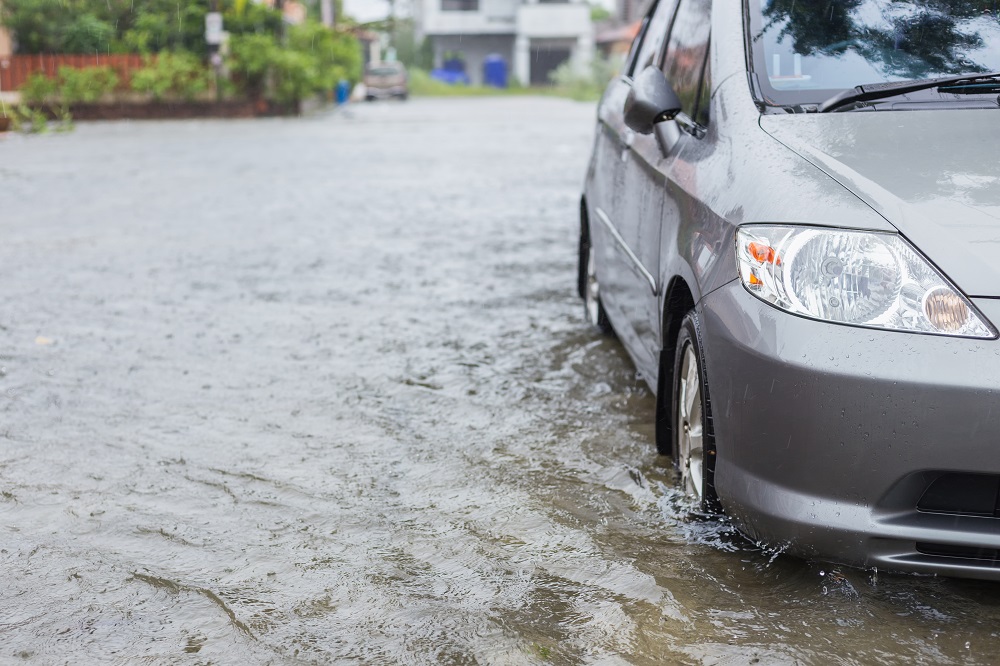 Car parking on the street of village while raining