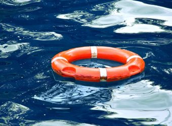 Red lifebuoy in blue water.