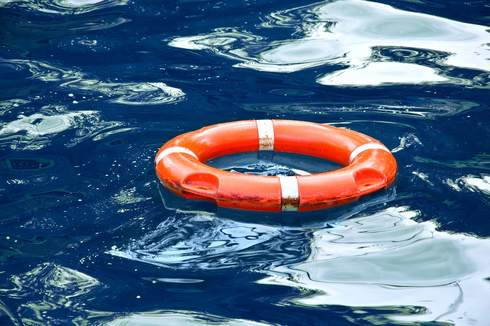 Red lifebuoy in blue water.